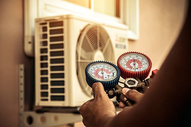 Professional Air Conditioning Service technician working in Springfield, MI